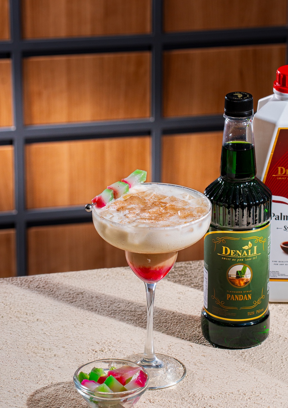 Selendang Mayang versi modern dengan Denali Red Coconut Syrup, Palm Sugar Syrup, Pandan Syrup, coconut milk, dan garnish kue Selendang Mayang.